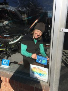 Clean Machine employee placing "Breastfeeding Welcome Here" sign on front window