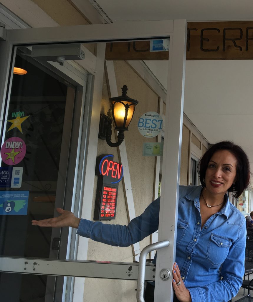 Monterrey Mexican Restaurant Village Plaza Chapel Hill employee pointing to Breastfeeding Welcome Here cling on the front door