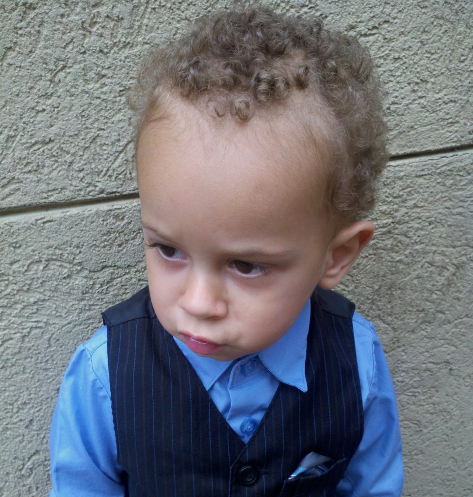 Young child frowning, looking away from the camera.