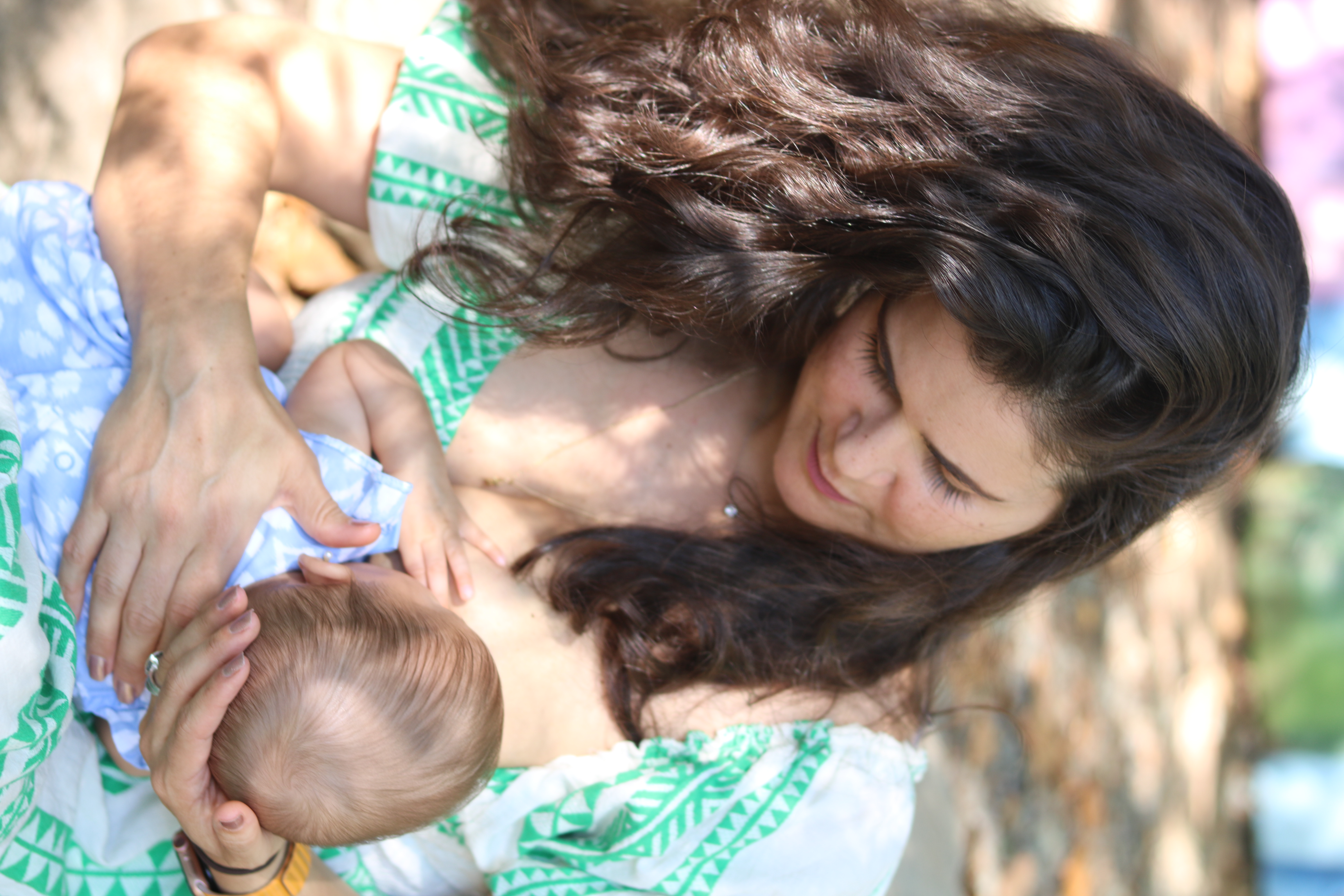 Mother nursing her infant outdoors