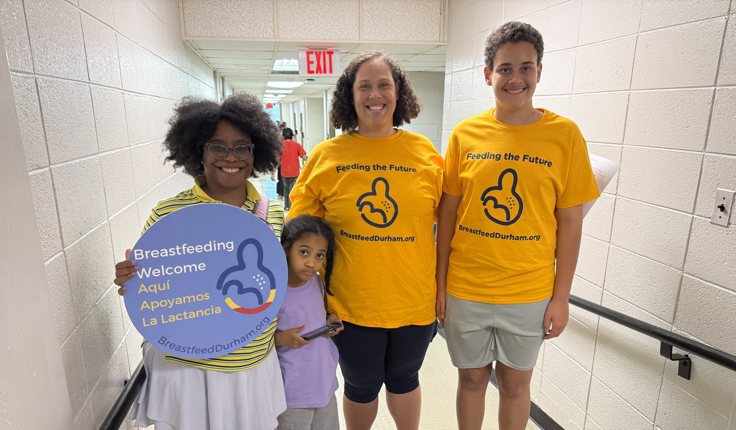 Breastfeed Durham volunteers holding a Breastfeeding Welcome sign